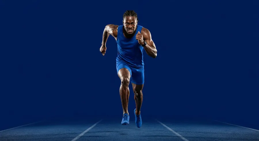Sprinter in a blue kit driving forward at full speed